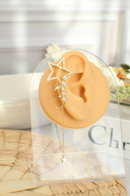 Puño de oreja con estrella y perlas